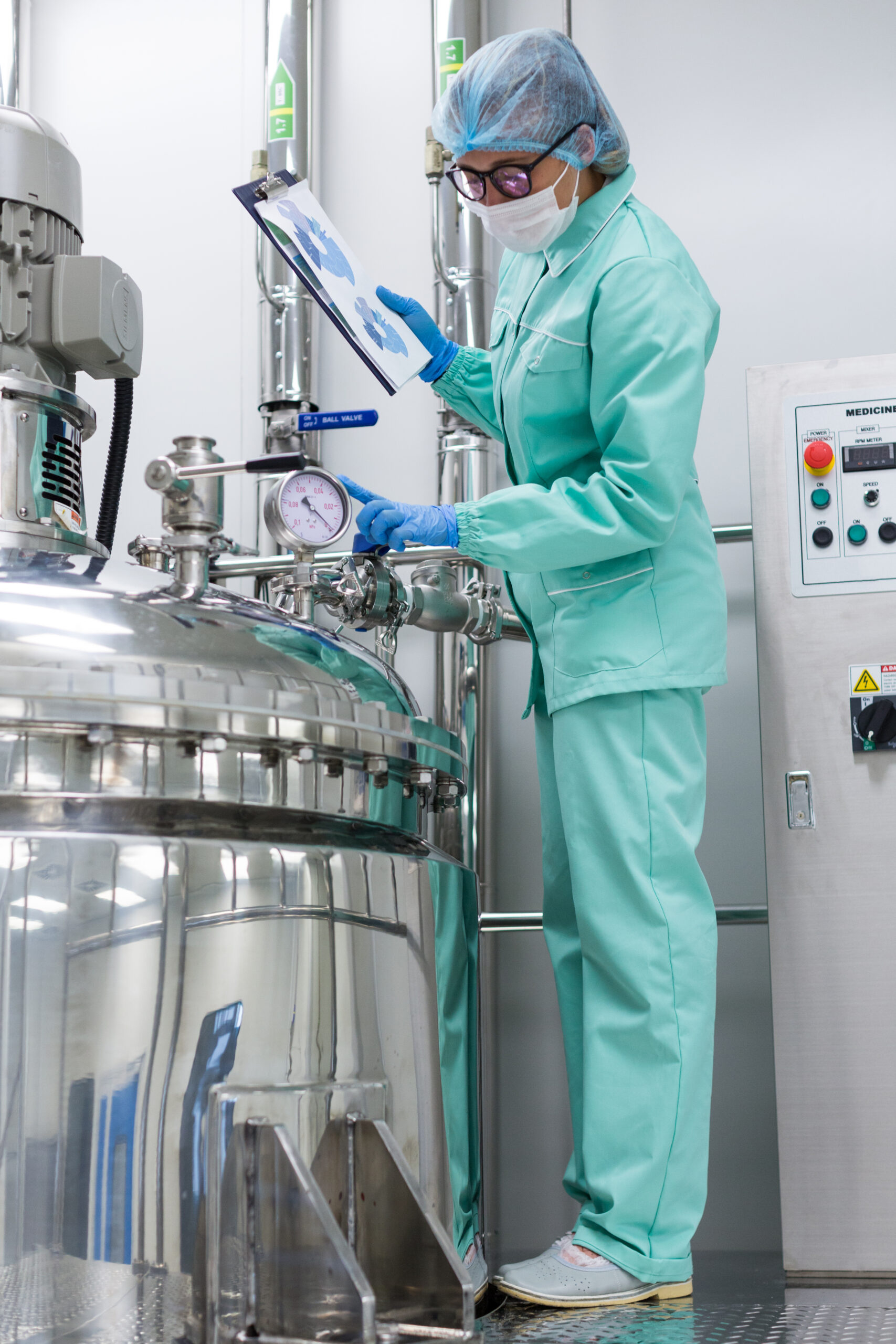 A woman in a lab coat working on a machine at Cambridge Consulting.