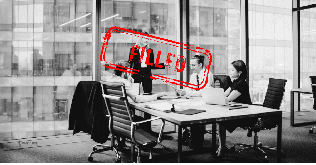 FILLED Account Manager 1736 a black and white image of a corporate meeting in a conference room with a red stamp overlay that says "filled"