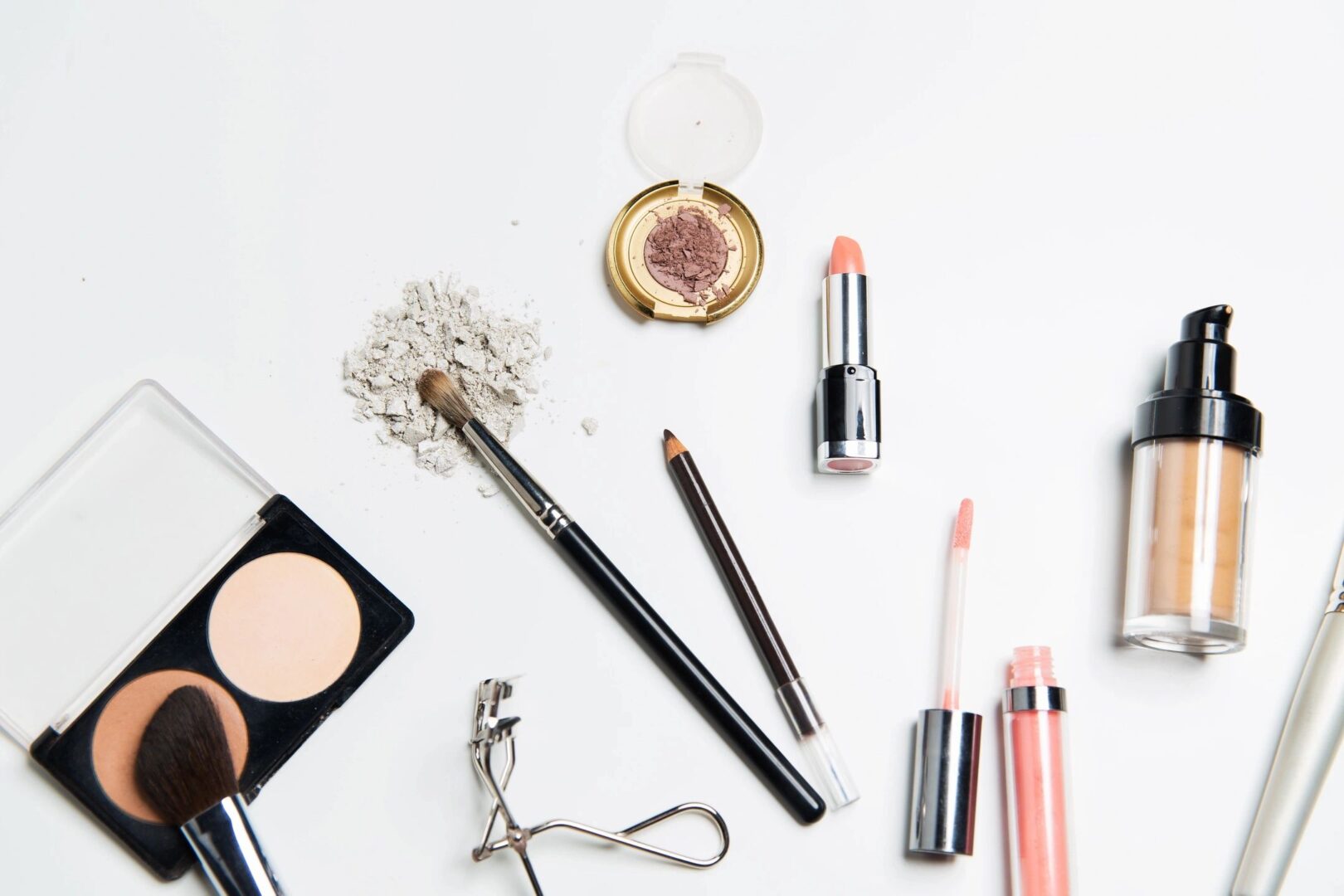 colorful makeup products laid out against a stark white background