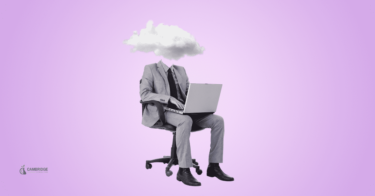 corporate worker sitting in a chair with a laptop with a cloud in the space where his head should be