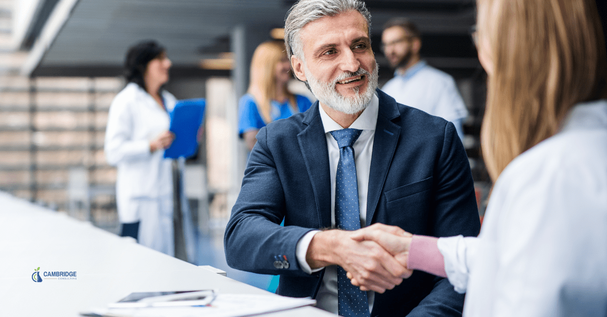 a sales man shaking hands with a client after closing a deal