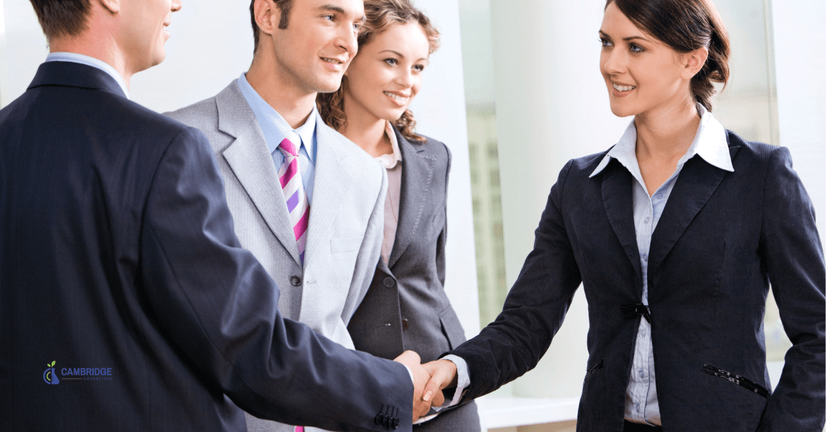 corporate sales woman shaking hands with colleagues