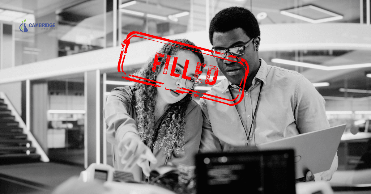 a black and white image of a man and a woman working together at a plant with a red text overlay that says "filled."