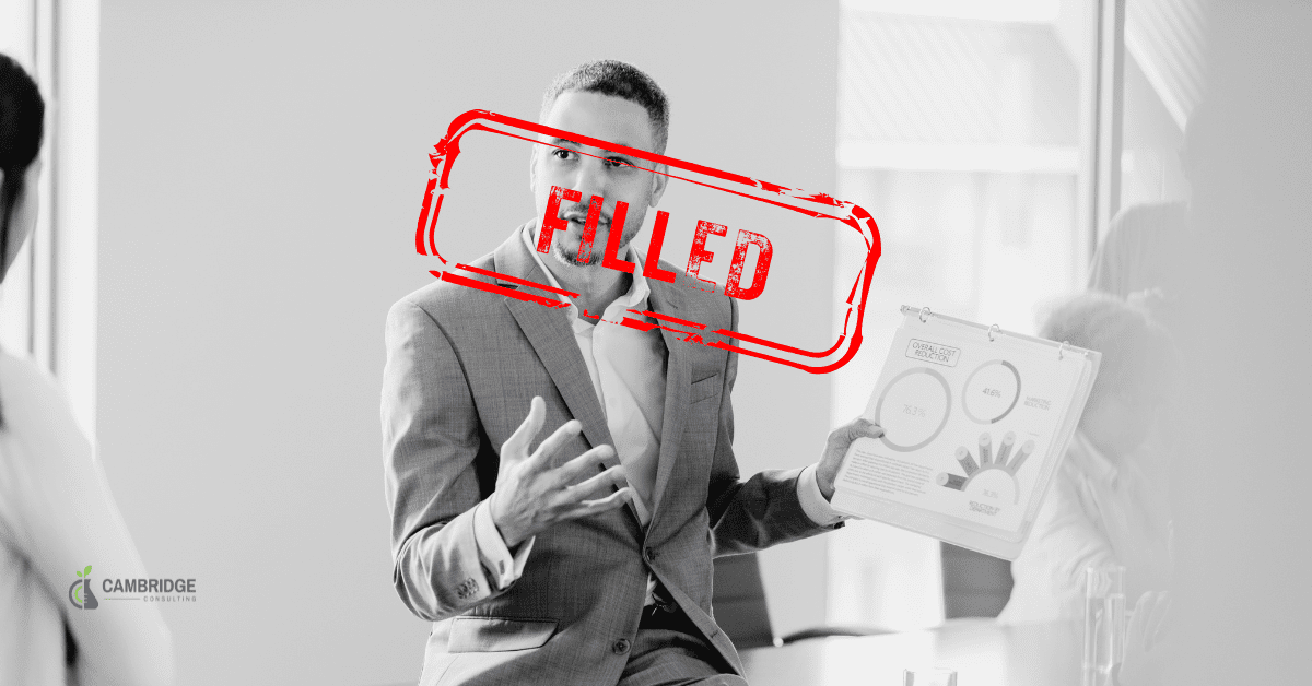 a black and white image of a business man giving a presentation with a red text overlay that says "filled."