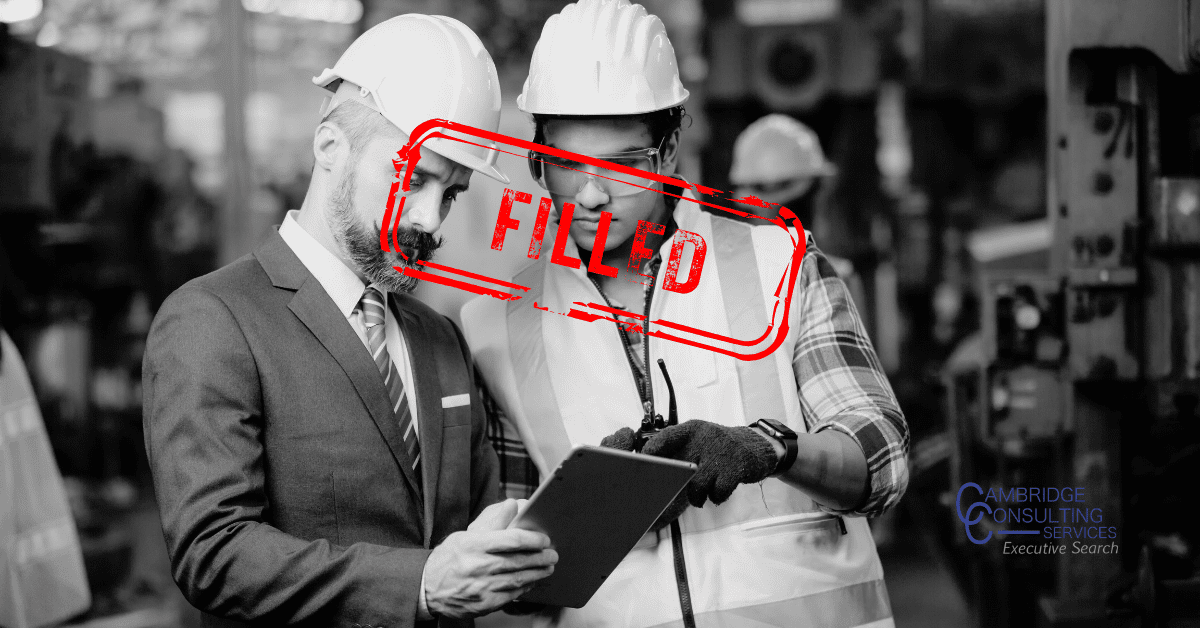 a black and white image of two men talking in a production plant with a red text overlay that says "filled." The Cambridge Consulting Services logo is in the bottom right corner.