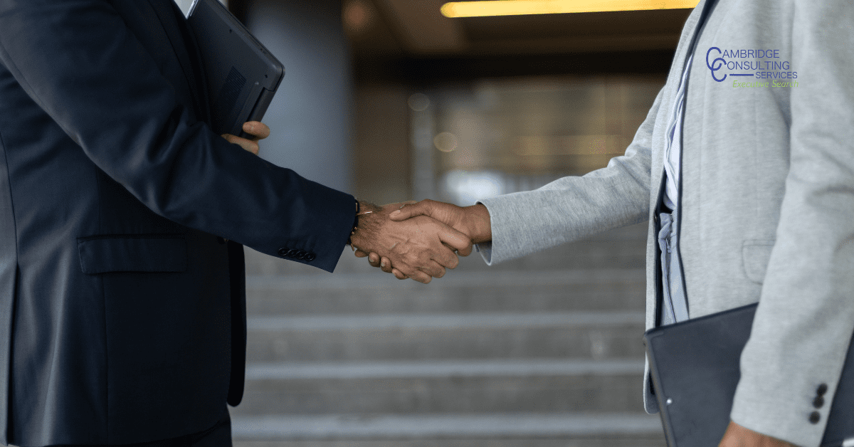 a photo of two corporate people shaking hands with the Cambridge Consulting Services logo in the top left corner