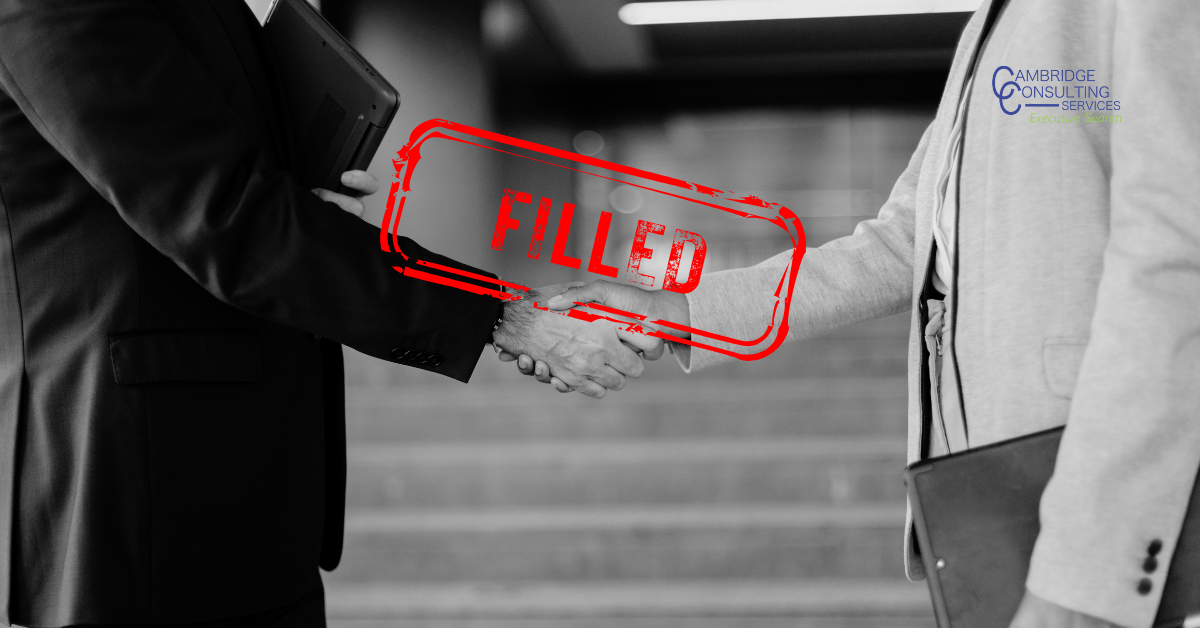 a black and white image of two men shaking hands with a red stamp overlay that says "filled" with the Cambridge Consulting Services logo in the top right corner
