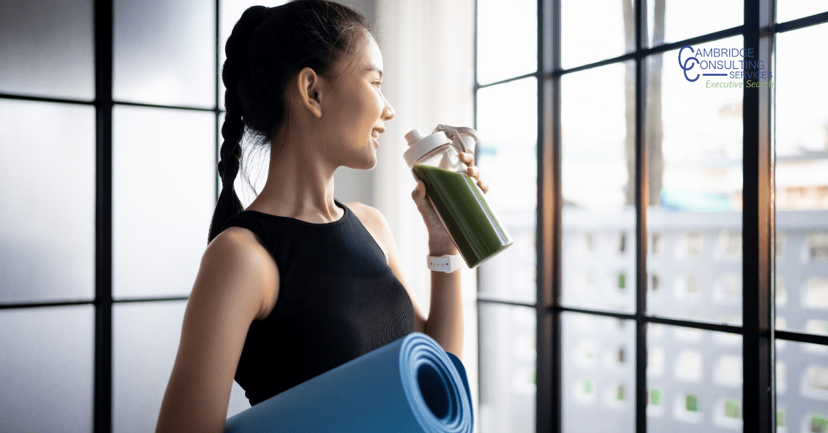 a photo of a woman drinking a sports drink with the Cambridge Consulting Services in the top right corner