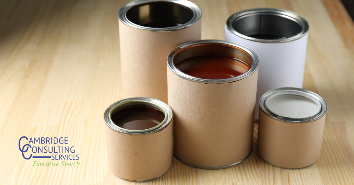 a photo of five different sized paint cans with the Cambridge Consulting Services logo in the bottom left corner